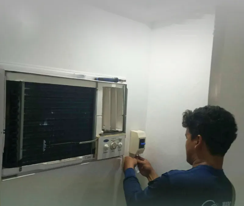 A window-type aircon unit being serviced on site
